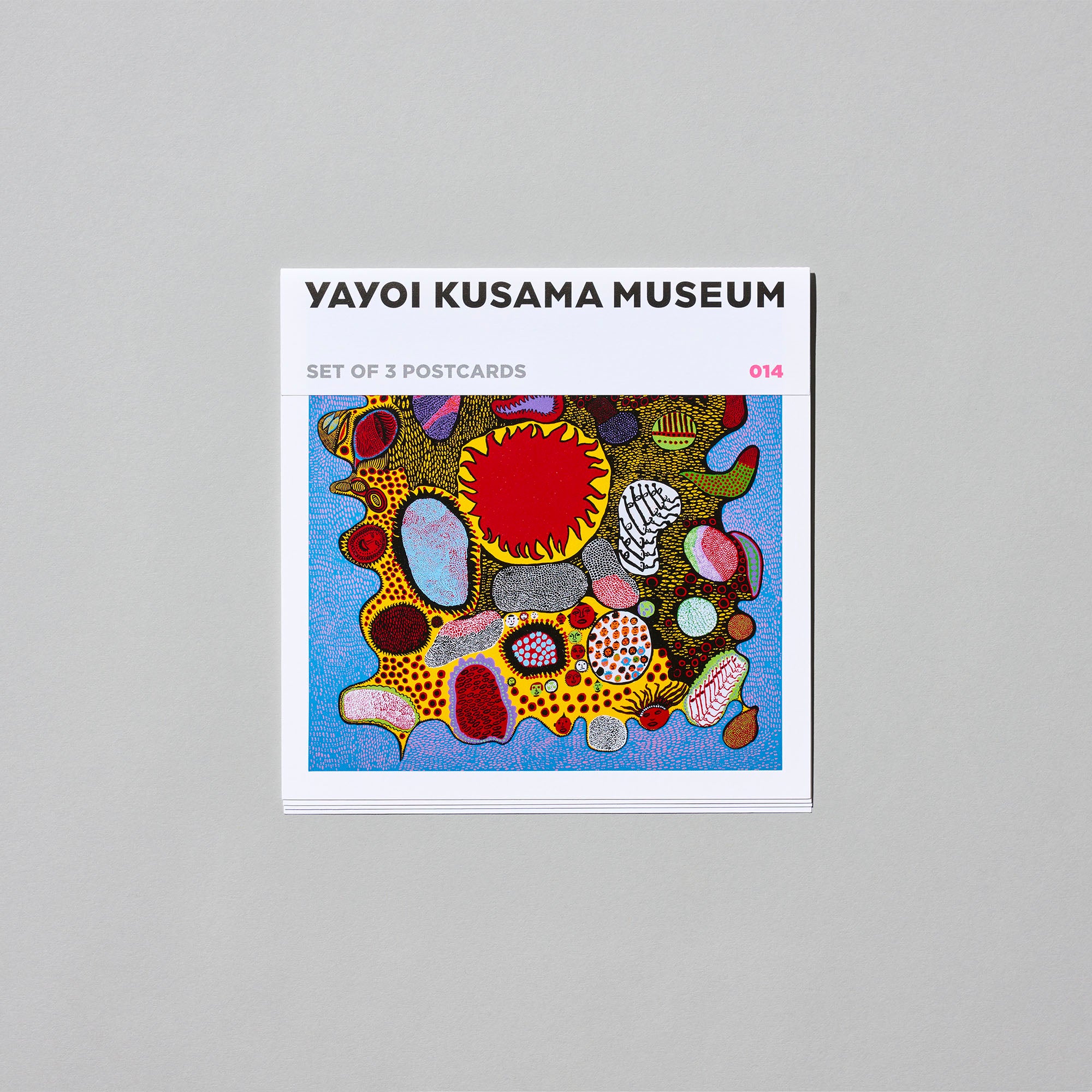 A square packaged postcard set labeled "YAYOI KUSAMA MUSEUM" with a colorful abstract postcard visible.