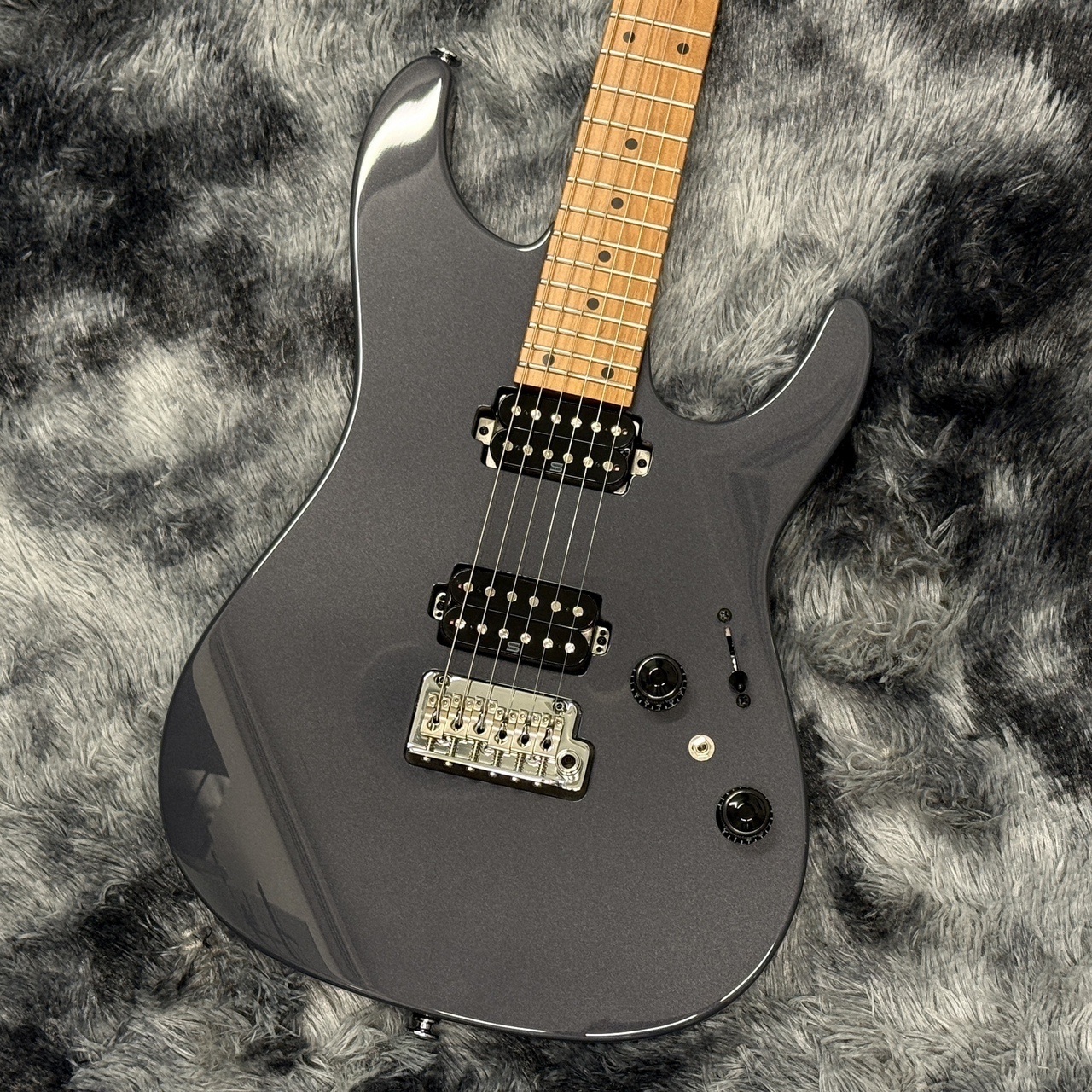 Ibanez Prestige AZ2402-GRM electric guitar shown front on a soft background, displaying a gray body, light-colored neck, pickups, and bridge.