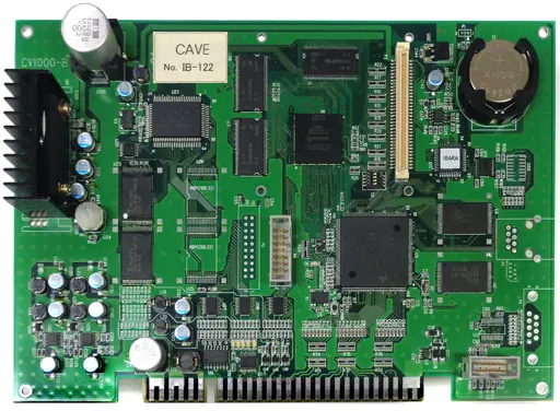 Top-down photo of the arcade PCB board showing integrated circuits, connectors, capacitors, and a coin-cell battery.