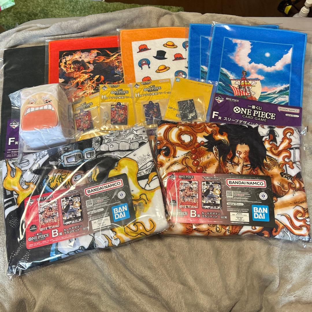 Packaged One Piece handkerchiefs and related Ichiban Kuji card game merchandise arranged on a surface.