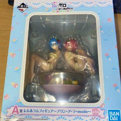 Windowed boxed Re:Zero A‑prize Rem and Ram figure set (Purin à la mode) visible in packaging.