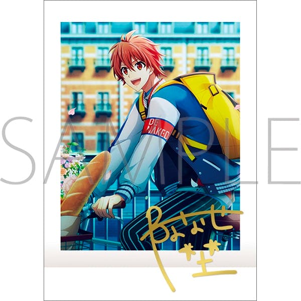 A sample photocard from the set showing an illustrated red‑haired male character on a bicycle with a yellow backpack, a visible SAMPLE watermark, and a gold printed signature.