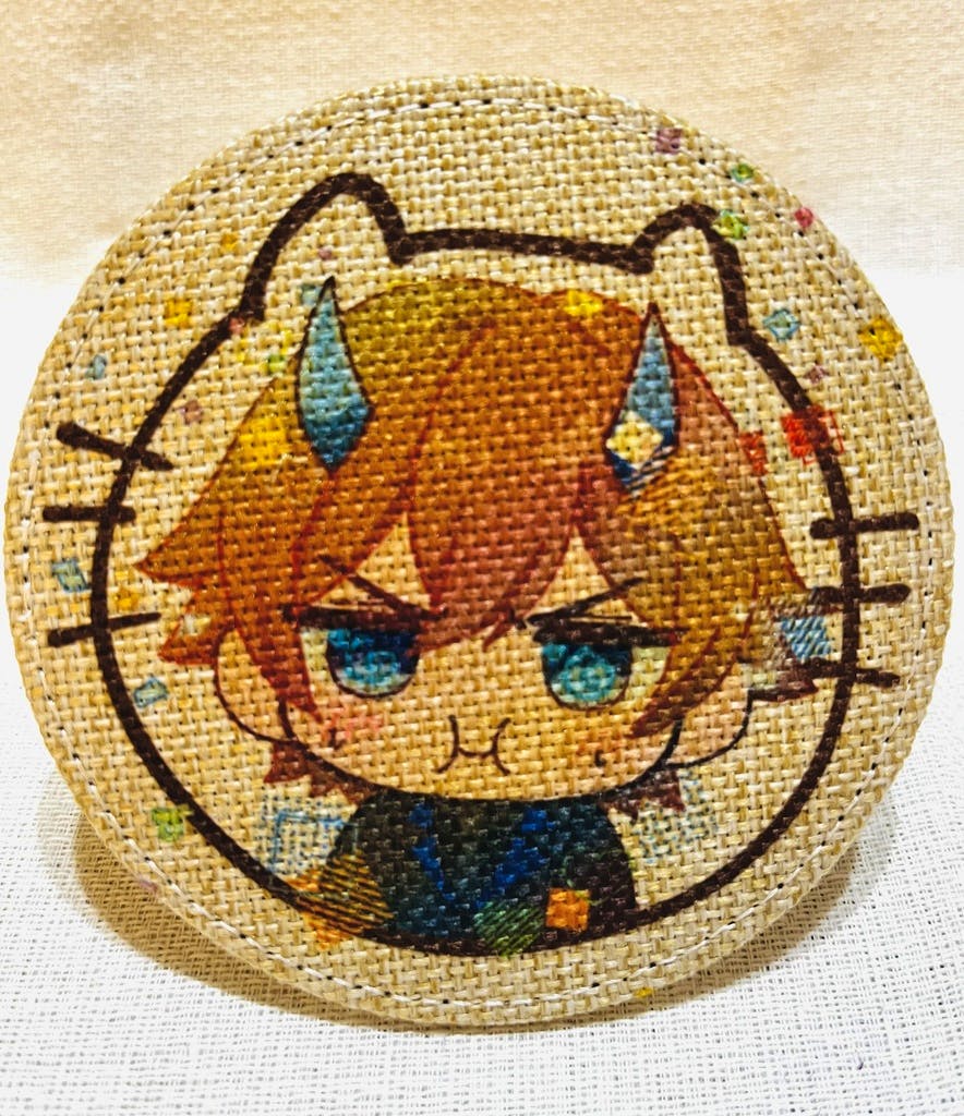 Round linen-style coaster showing a chibi character with brown hair, blue eyes, and small horns.
