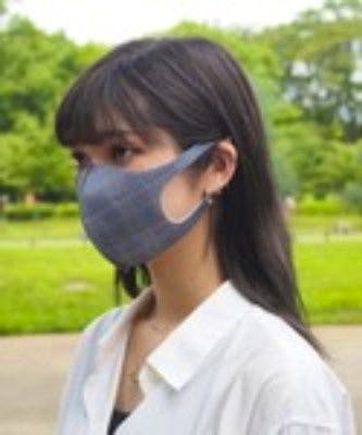 Woman wearing the IKplus MA-05-p 3D washable printed mask outdoors.