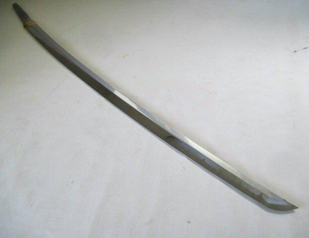 Full-length metal imitation iaito-style sword with visible hamon pattern laid on a white surface.