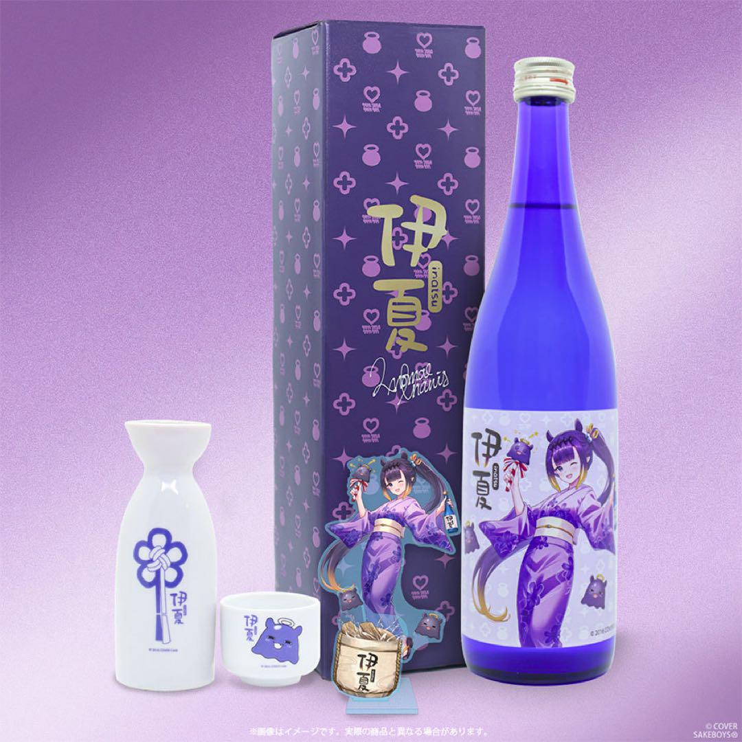 A 720ml purple sake bottle with character label shown with its matching purple box, a white tokkuri (sake flask), a white ochoko (sake cup), and small accessories.
