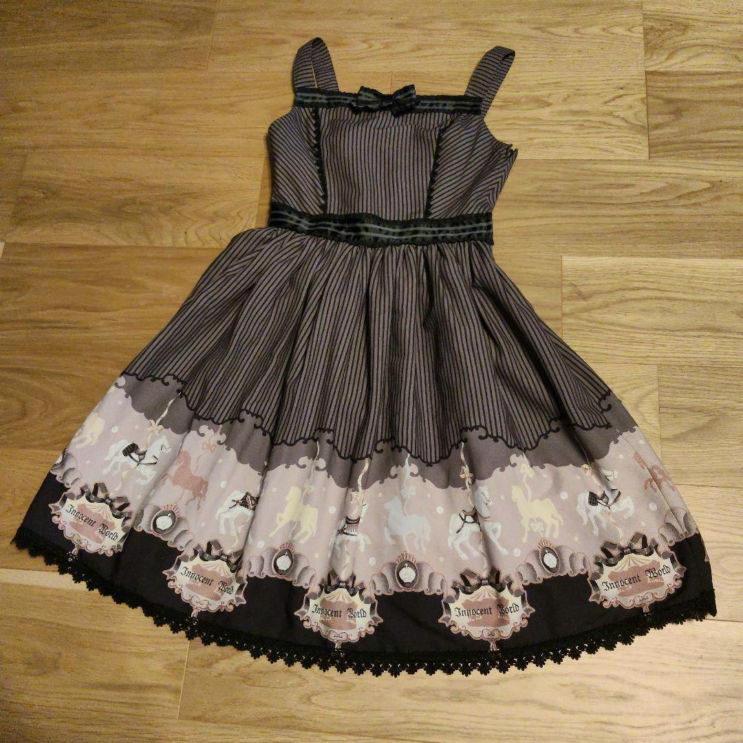 Flat-laid Innocent World jumper skirt showing a striped bodice and horse-print border hem.