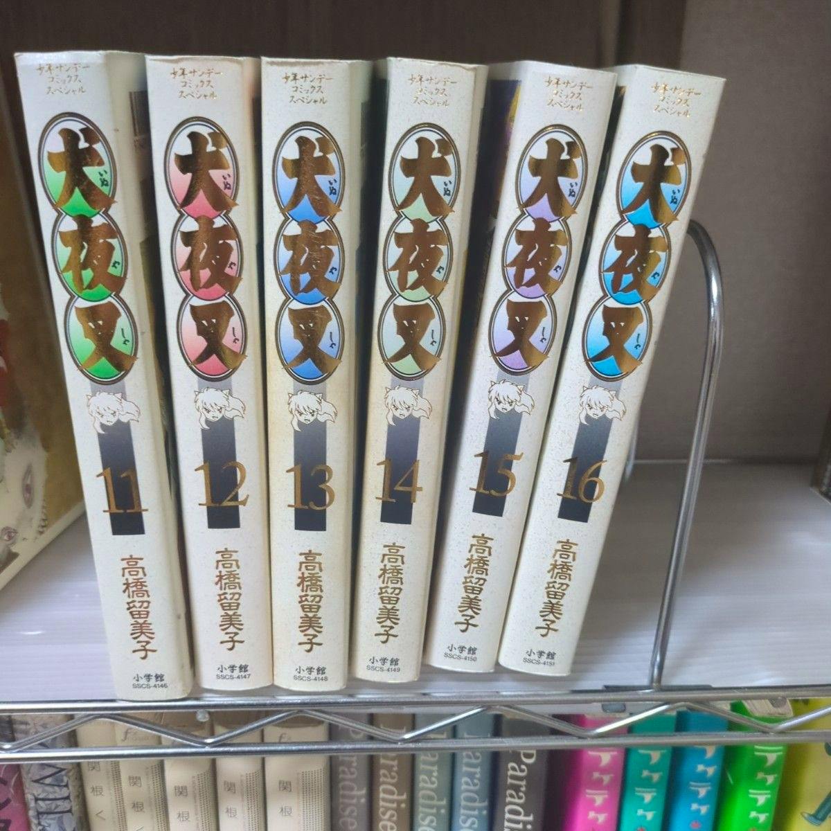 Spines of six Inuyasha wide-edition manga volumes (volumes 11–16) lined up on a shelf.