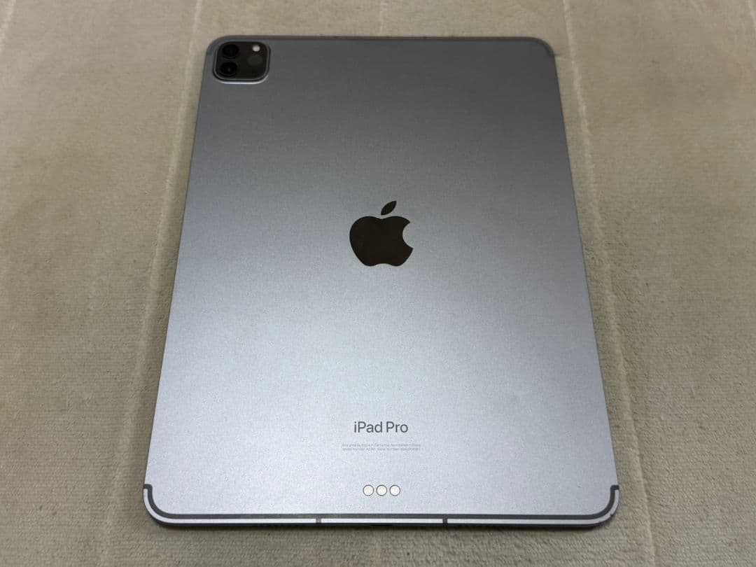 Rear view of the iPad Pro 11‑inch showing the Apple logo, rear camera module, and Smart Connector.