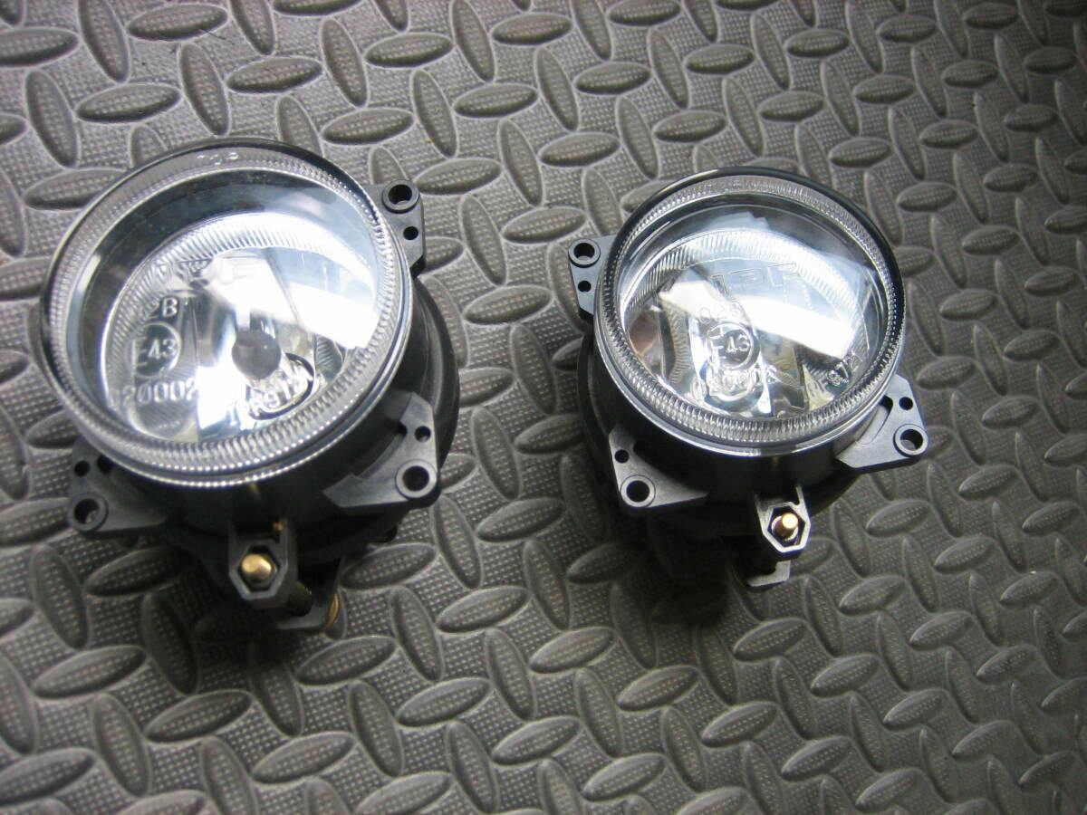 Front view of the IPF fog lamp pair (left and right) placed on a textured mat.