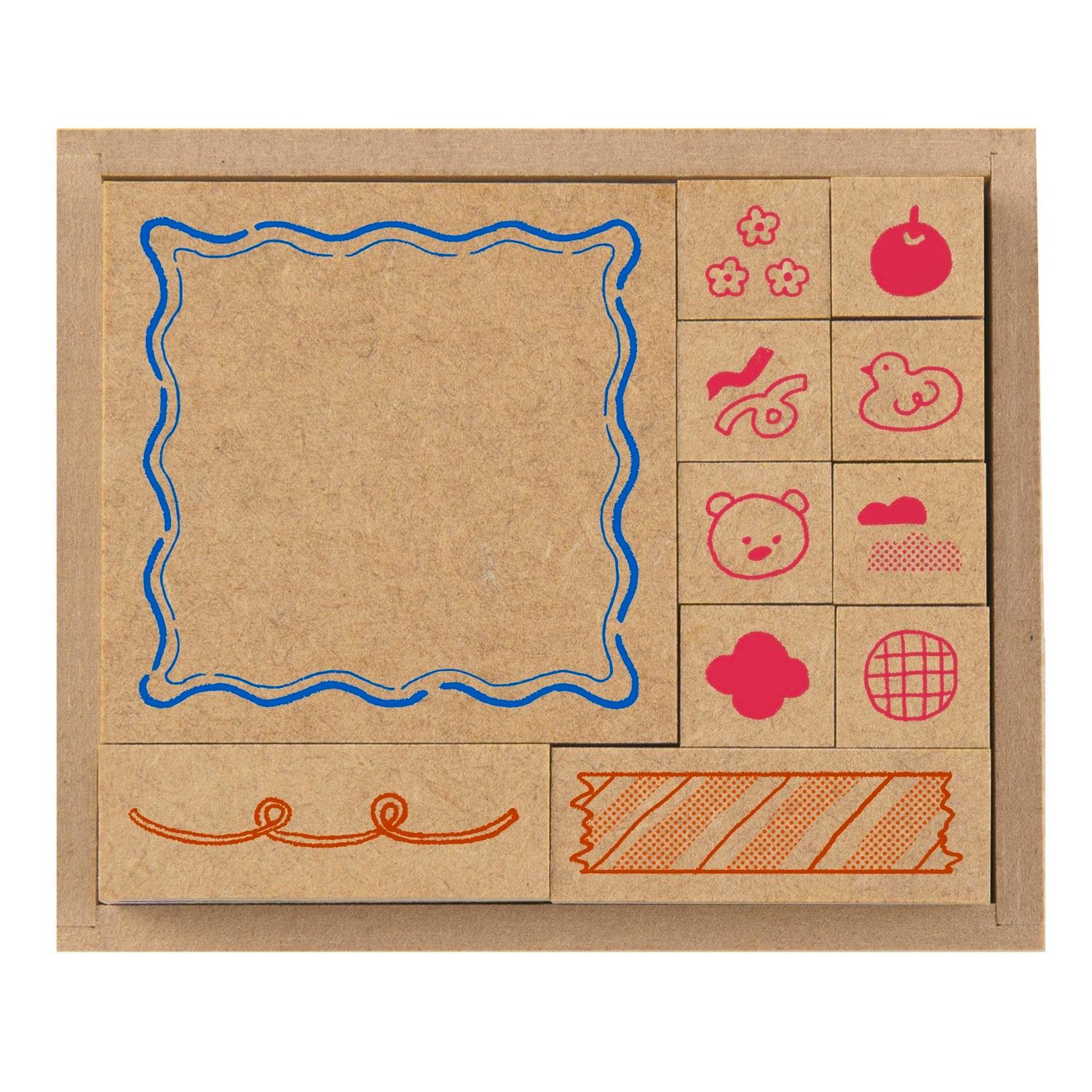 Top-down view of a wooden stamp set in its tray showing multiple small decorative wooden stamps with printed icons on their faces.