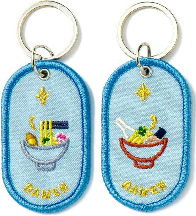 Two embroidered fabric keychain patches showing ramen bowls attached to metal key rings.