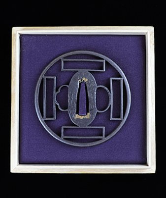Iron tsuba (sword guard) with square and rectangular cutouts displayed in a square frame on a purple background.