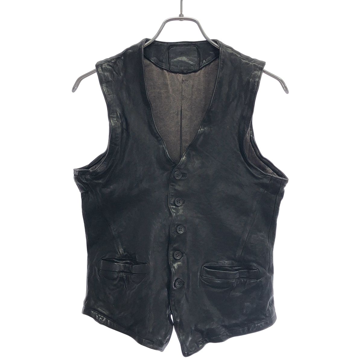 Front view of a black cow leather vest hanging on a hanger.