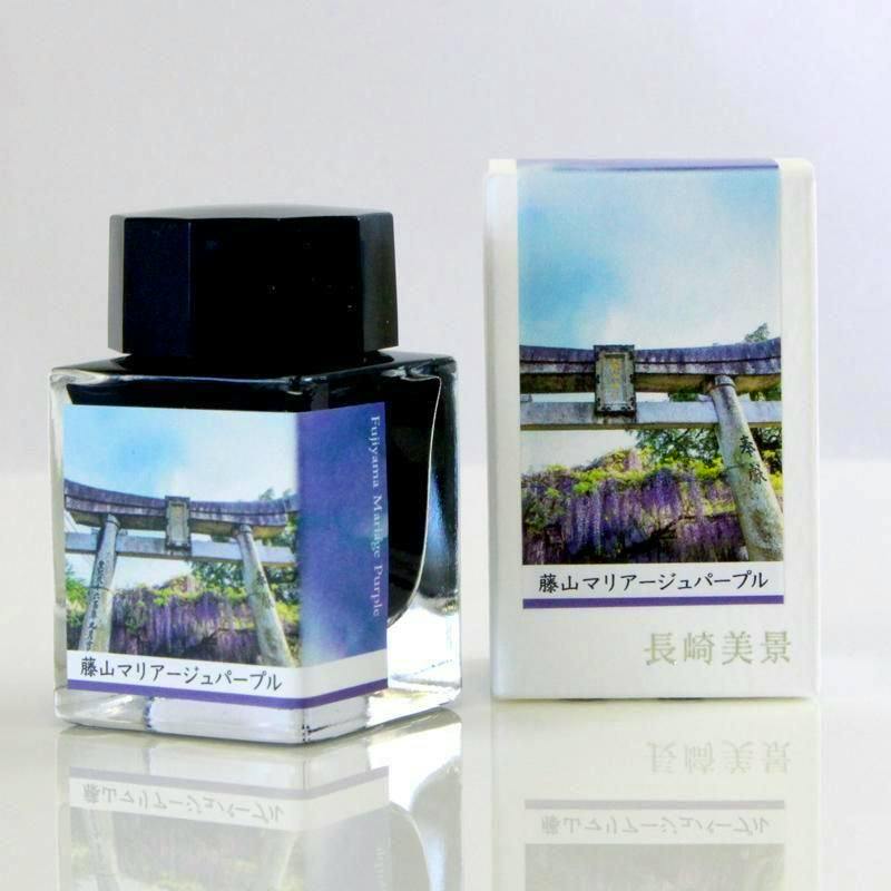 A fountain pen ink bottle and its printed packaging box showing a torii gate and wisteria design on a white surface.