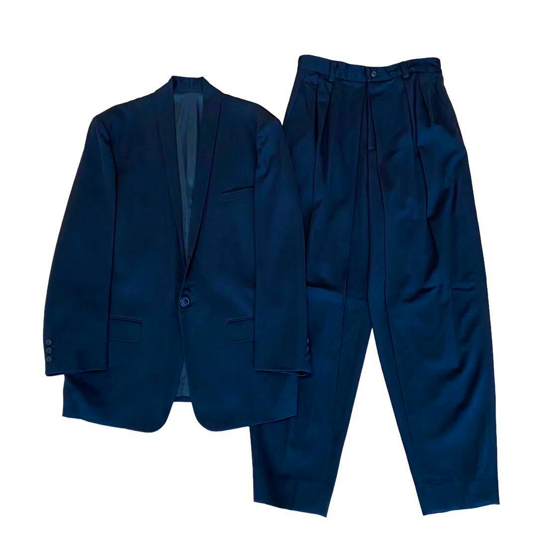 A men's wool jacket and matching trousers laid flat on a white background.