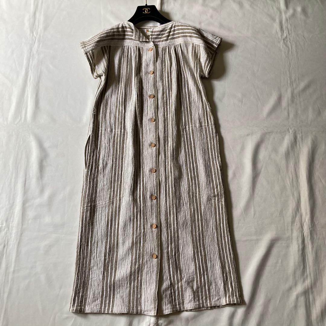 Front view of an Issey Sports (Issey Miyake) women's cotton dress laid flat, showing vertical stripes and a center-front button closure.