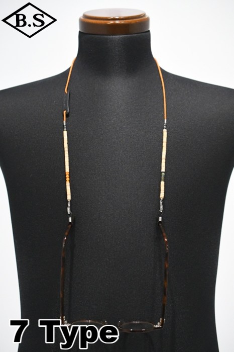 Glasses-holder necklace (Varios Holder Heishi) displayed on a black mannequin bust with eyeglasses hanging from the cord.