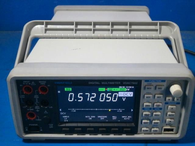 Front view of the IWATSU VOAC7602 digital multimeter showing its screen, keypad, and input jacks.