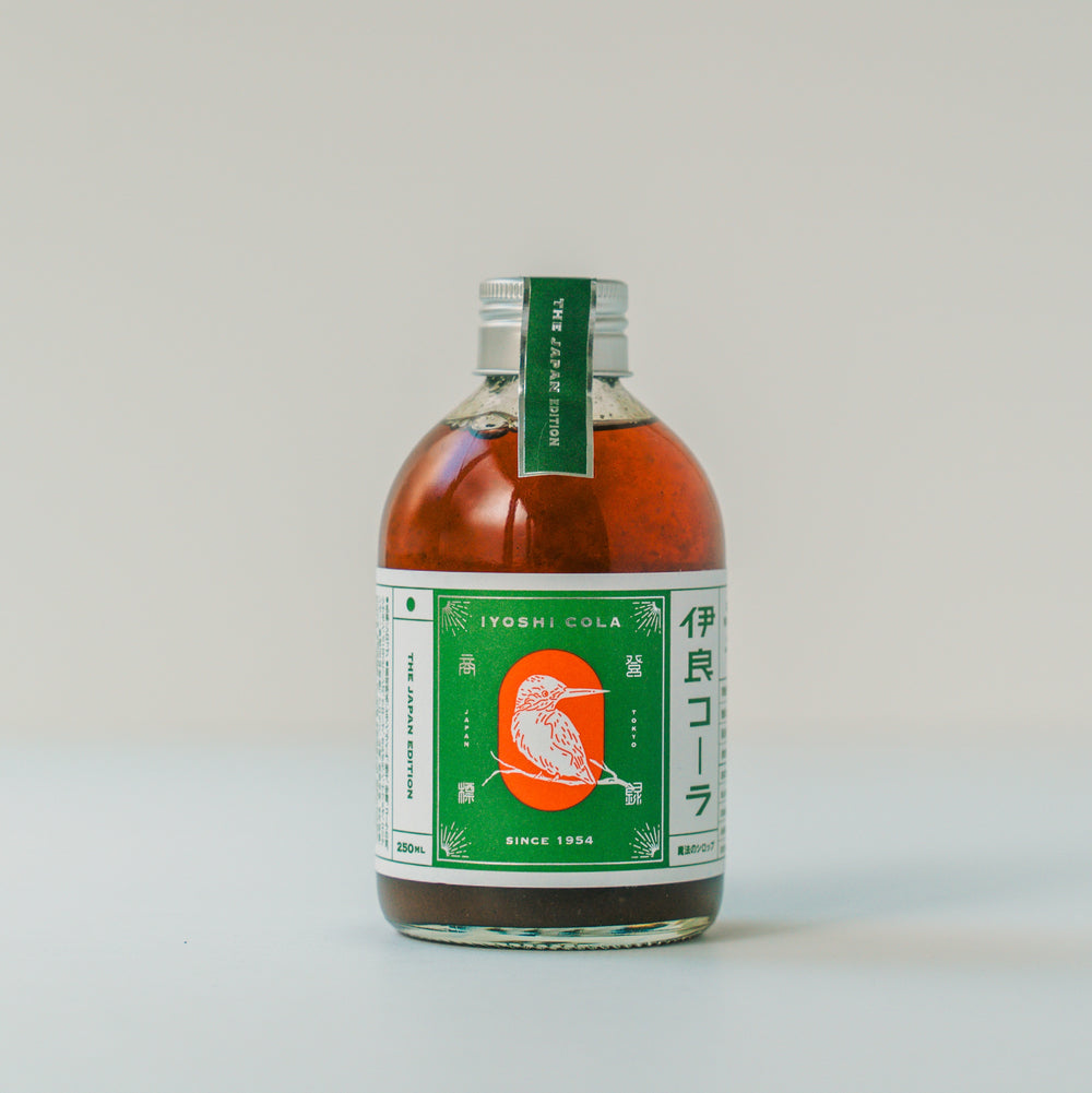 Front view of the M-size (250 ml) cola base syrup bottle with a green label and silver cap on a plain background.