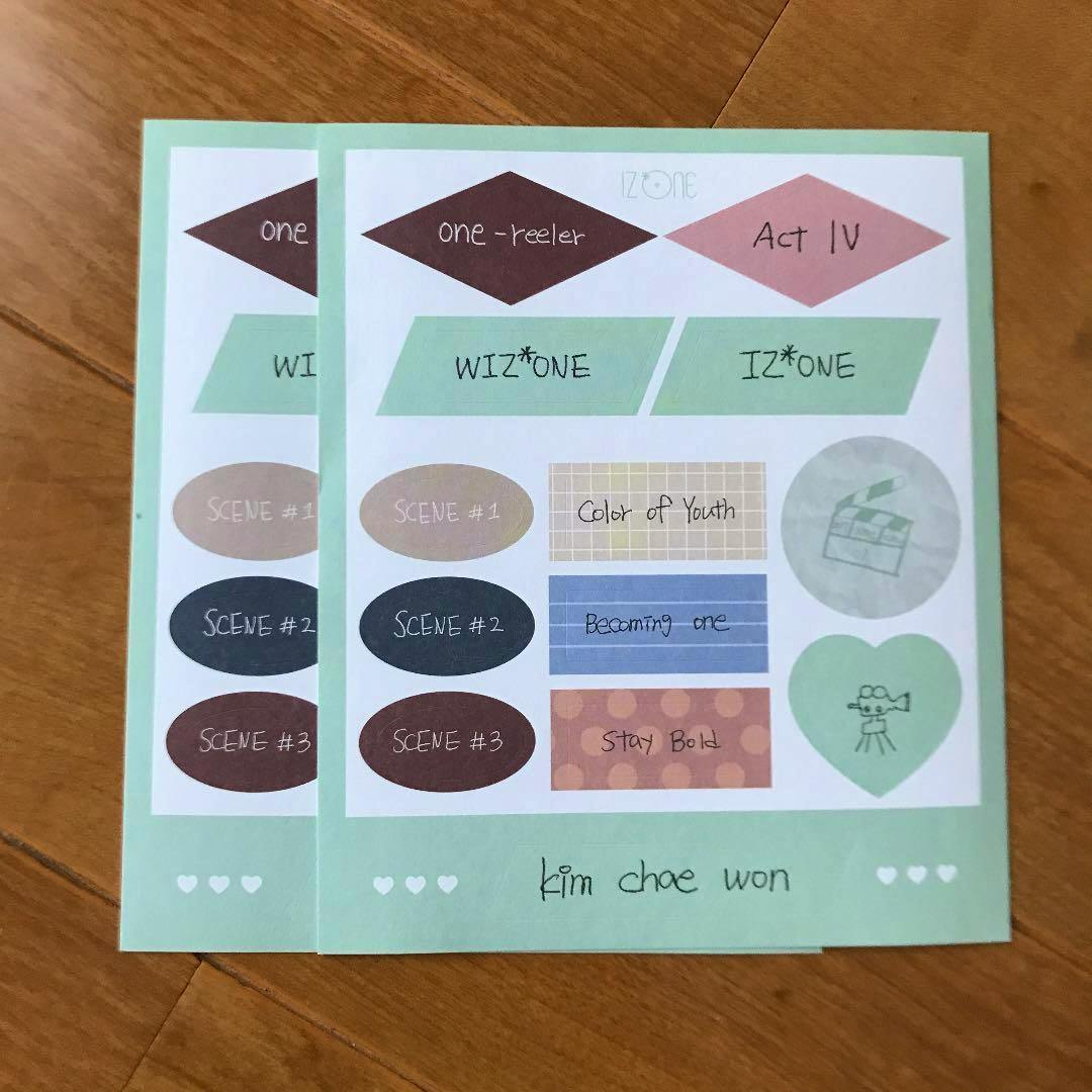 Paper sticker sheet with a mint-green border showing multiple small decorative stickers and the handwritten name "kim chae won".