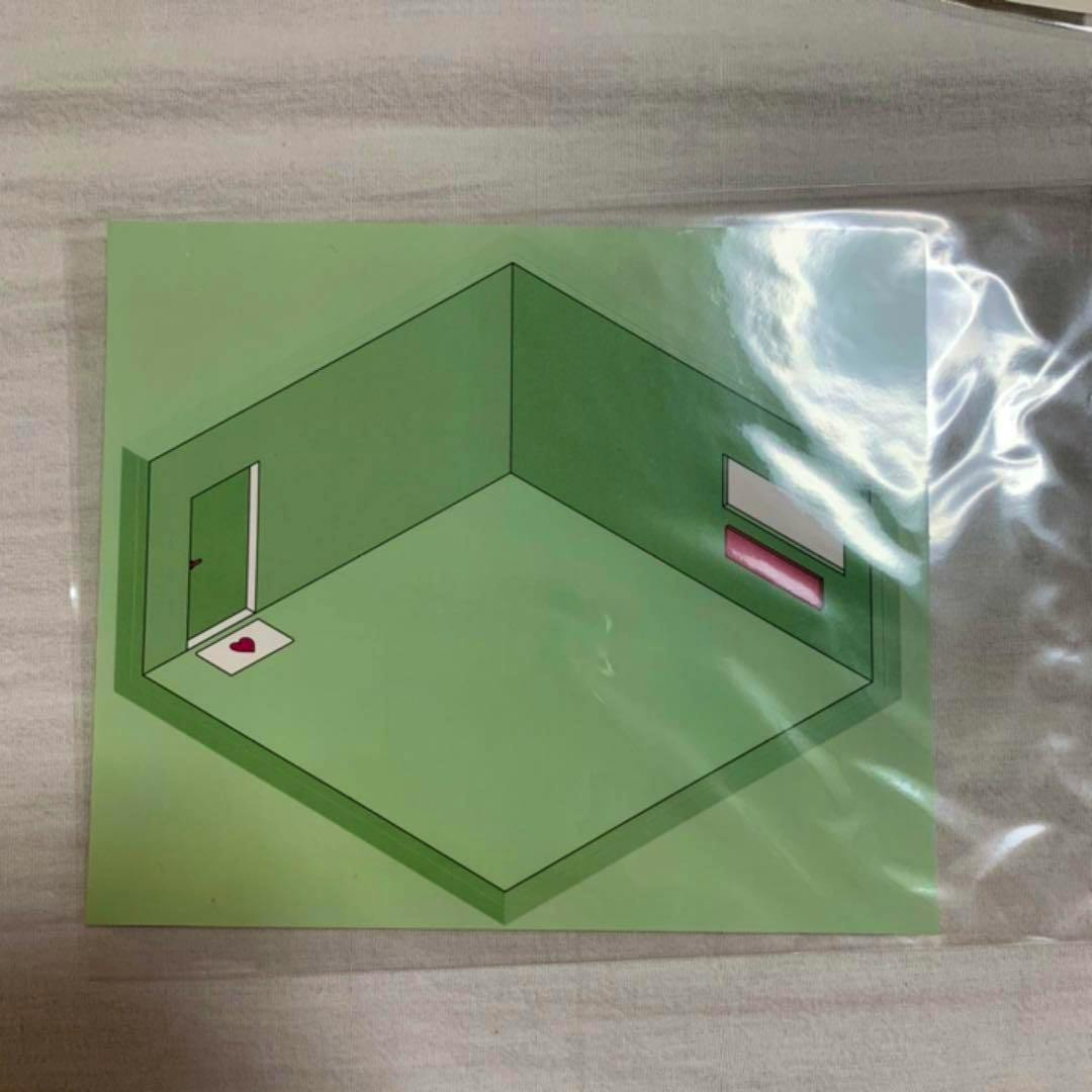 A green isometric room illustration paper sticker shown inside clear plastic packaging.