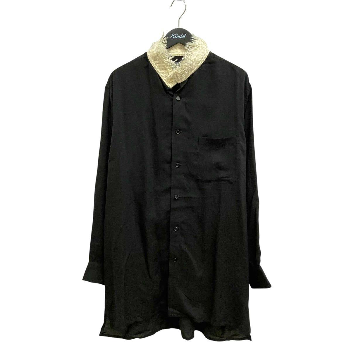 Front view of a black long-sleeve mens shirt on a hanger with buttons, a chest pocket, and a beige fringed collar detail.