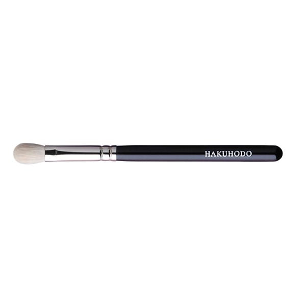 Eye shadow brush with a black handle labeled "HAKUHODO" and rounded white bristles on a white background.
