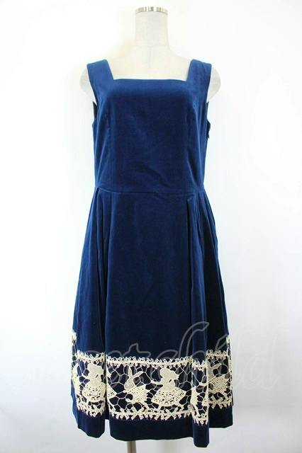 Front view of the navy square-neck Jane Marple women's dress with cream Alice lace along the hem displayed on a mannequin.