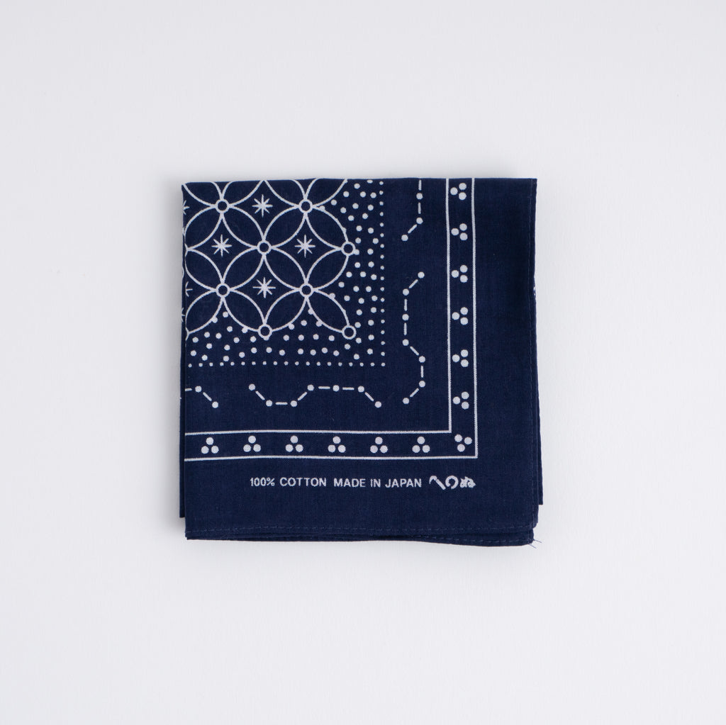 Folded navy cotton bandana showing a white star-patterned Japanese-style print on a white background.