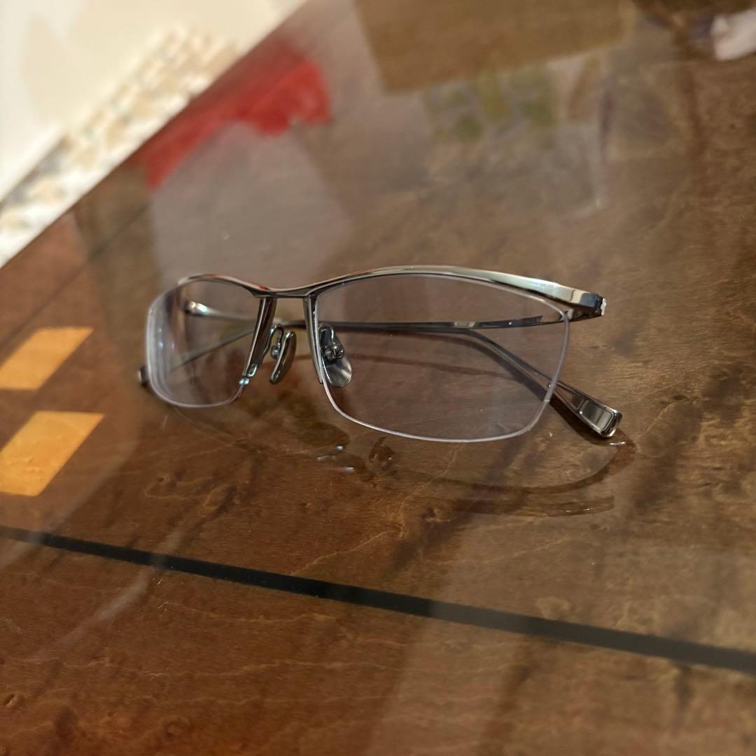 A pair of JAPONISM JN581 high-curve all-titanium glasses placed on a table.