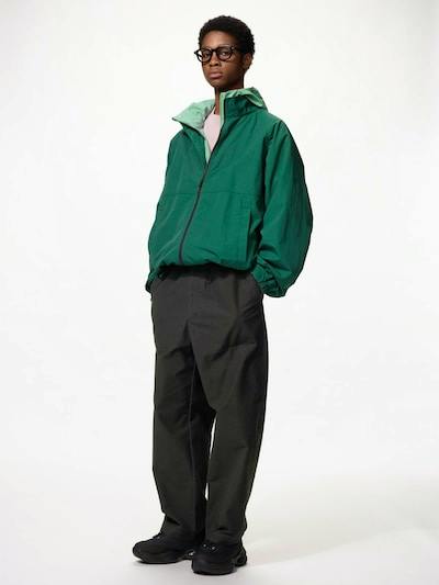 Male model wearing the men's work pants (dark gray) standing full-length against a white background.