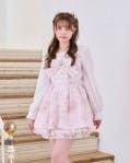Female model wearing a pink jewelry-pattern set-up dress.