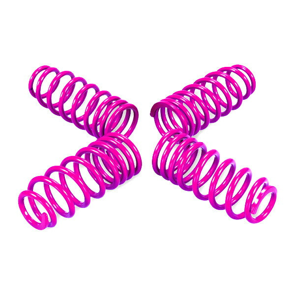 Four magenta car lowering coil springs on a white background.