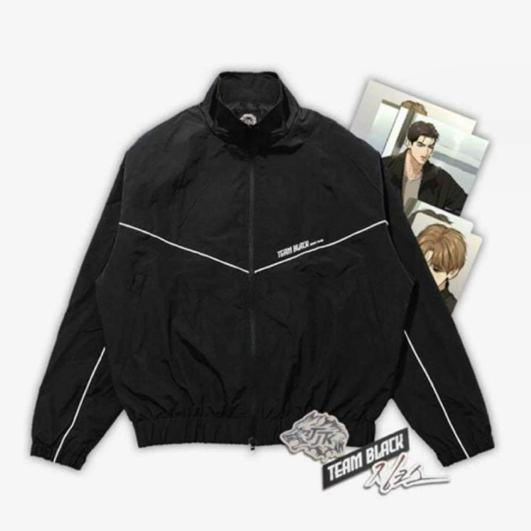 Flat-lay photo of a black men's windbreaker jacket with white piping and a visible "TEAM BLACK" logo.