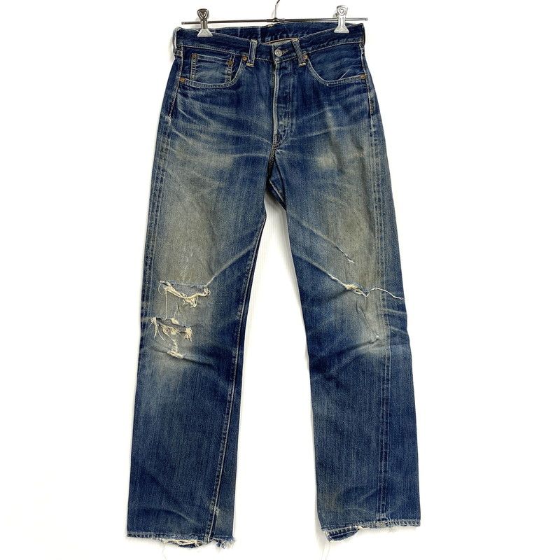 Front view of Joe McCoy LOT906 men's denim jeans with distressed knees hanging against a white background.