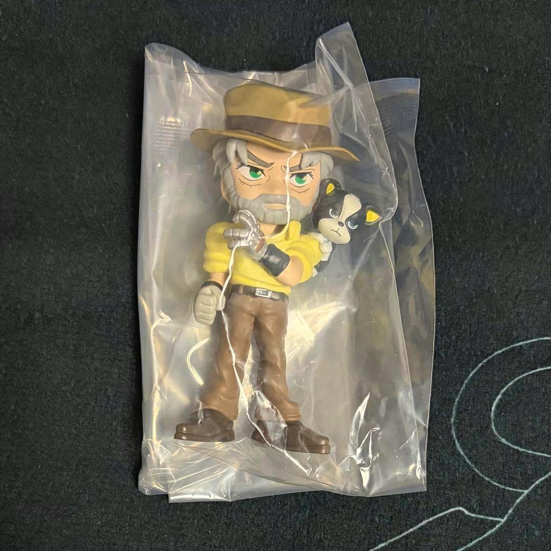 A plastic figure of Joseph from JoJo's Bizarre Adventure in a clear plastic bag, wearing a hat, yellow shirt, and brown pants.