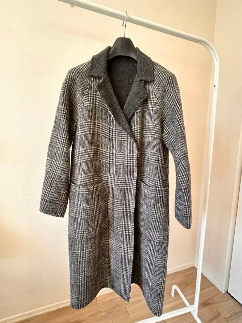 Front view of the women's wool reversible coat (journal standard relume) hanging on a clothing rack.
