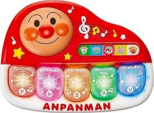 Red Anpanman baby piano toy showing an Anpanman face at the top and five colored keys across the front.