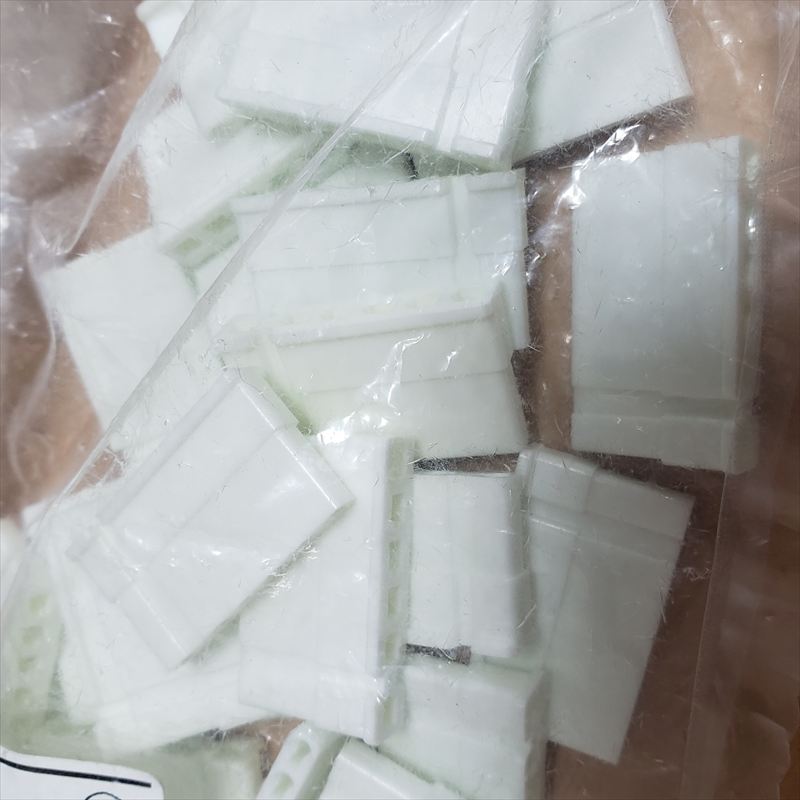 Several white 6-pin connector housings (JST style) visible together inside a clear plastic bag.