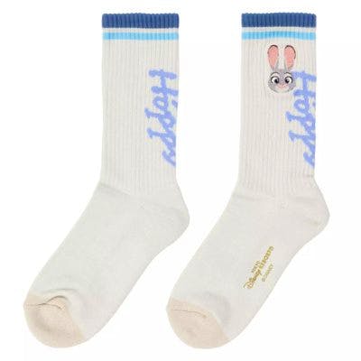 Pair of white men's cotton crew socks (22–25 cm) with blue cuff stripes, "Judy" text, and a small rabbit face design.