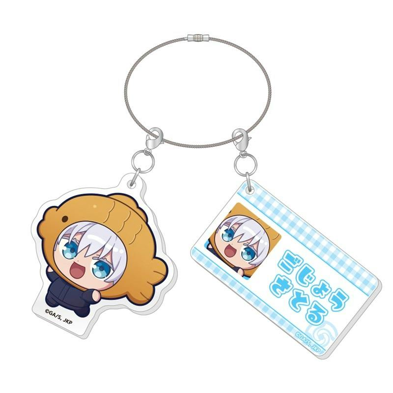 Two-piece acrylic keychain of Gojo Satoru showing a chibi charm with white hair and blue eyes wearing a brown hat and a rectangular blue-checked charm with Japanese text, both attached to a metal cable loop.