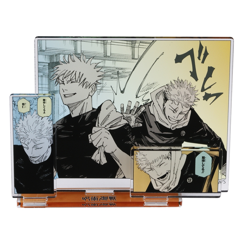 Photograph of the JCS limited ‘Jujutsu Kaisen’ acrylic diorama showing printed panels of Itadori Yuji and Gojo Satoru mounted on a clear orange base.
