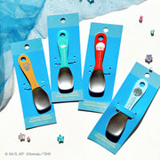 Four metal ice cream spoons with colored handles displayed on blue backing cards.