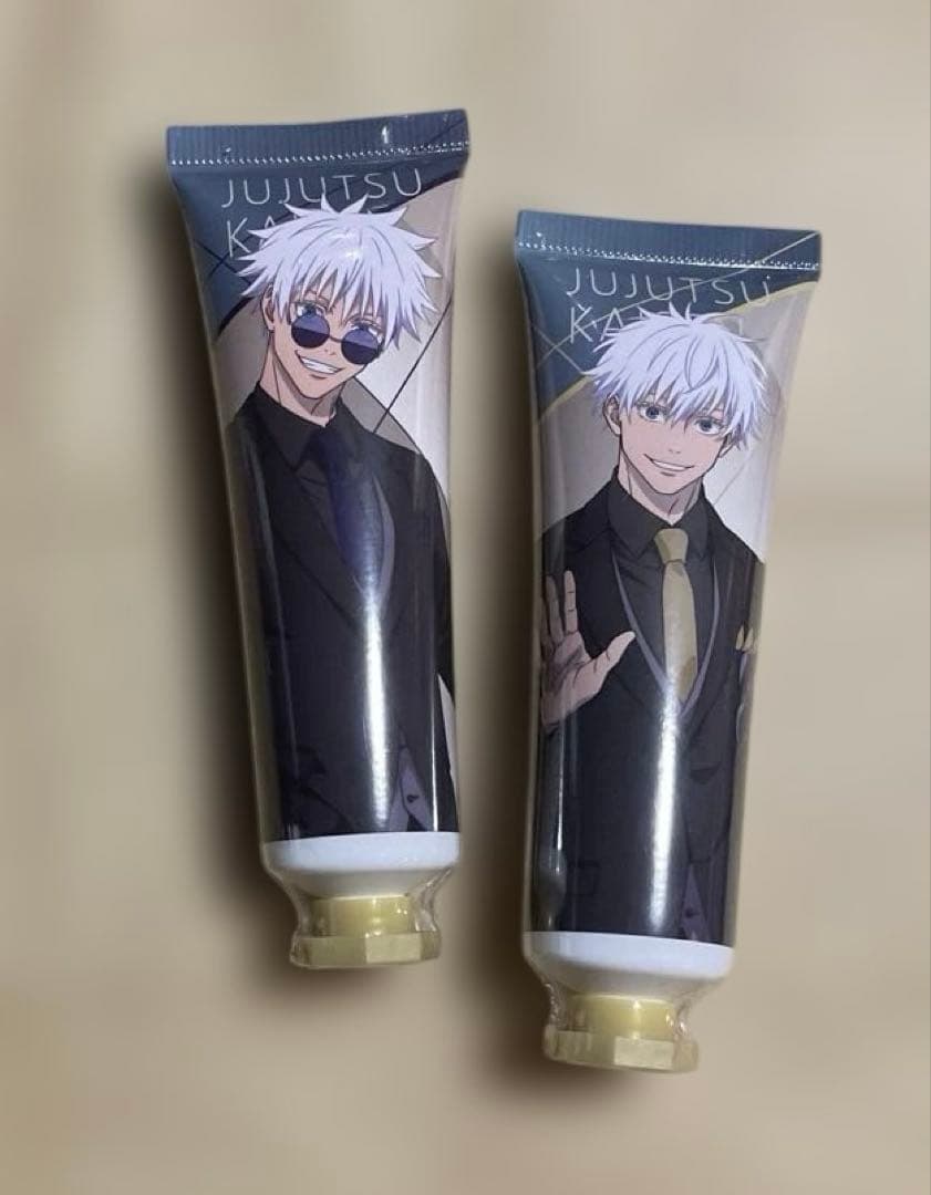 Two tubes of hand cream featuring Jujutsu Kaisen's Gojo Satoru in a suit shown on a plain background.