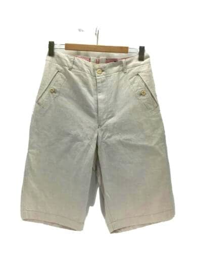 Front view of light-colored JUNYA WATANABE COMME des GARCONS shorts hanging on a hanger.