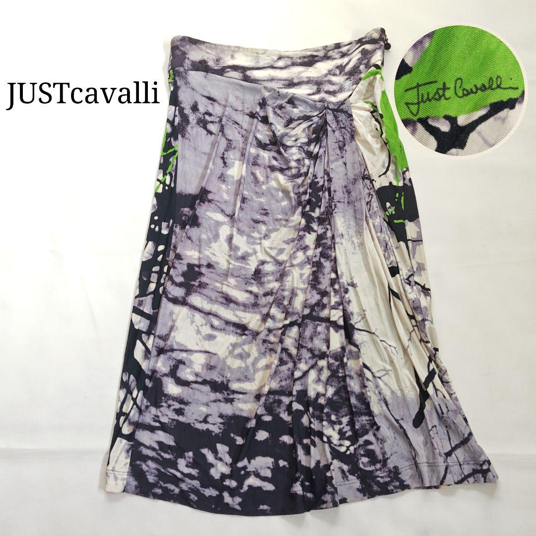 A women's Just Cavalli abstract graphic draped polyester skirt laid flat with a close-up of the label.