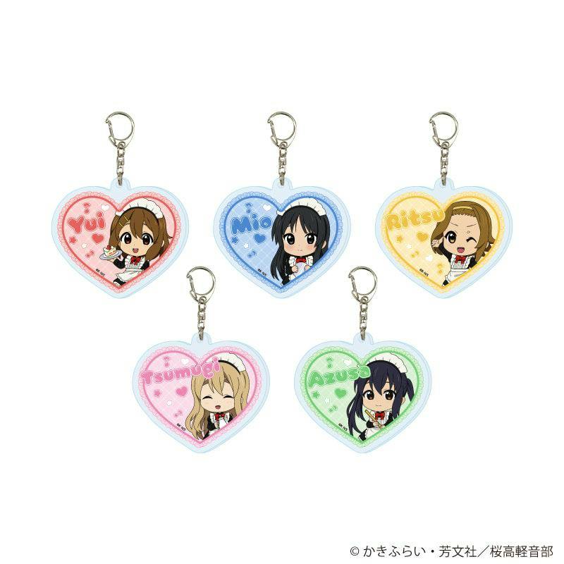 Five heart-shaped acrylic keychains showing mini chibi maid illustrations from TV anime "K-On!" arranged on a white background.