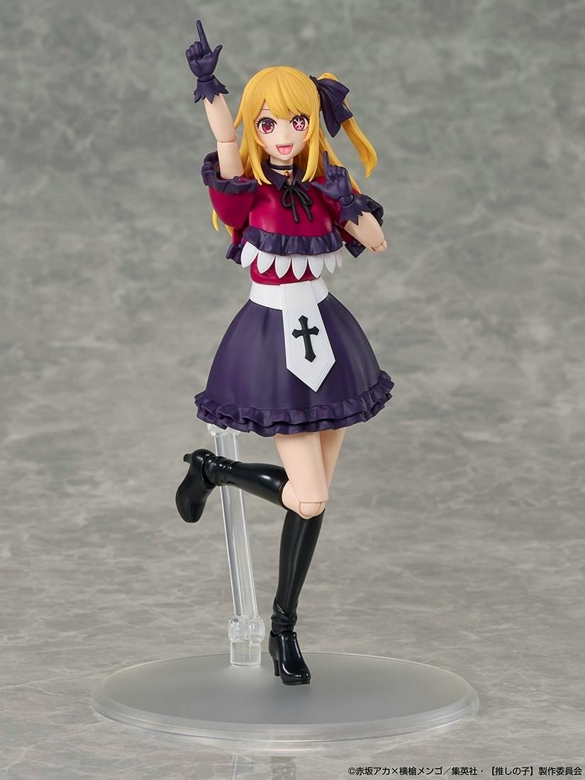 Plastic figure of Ruby from “Oshi no Ko” wearing a purple and red outfit posed on a clear round display stand.