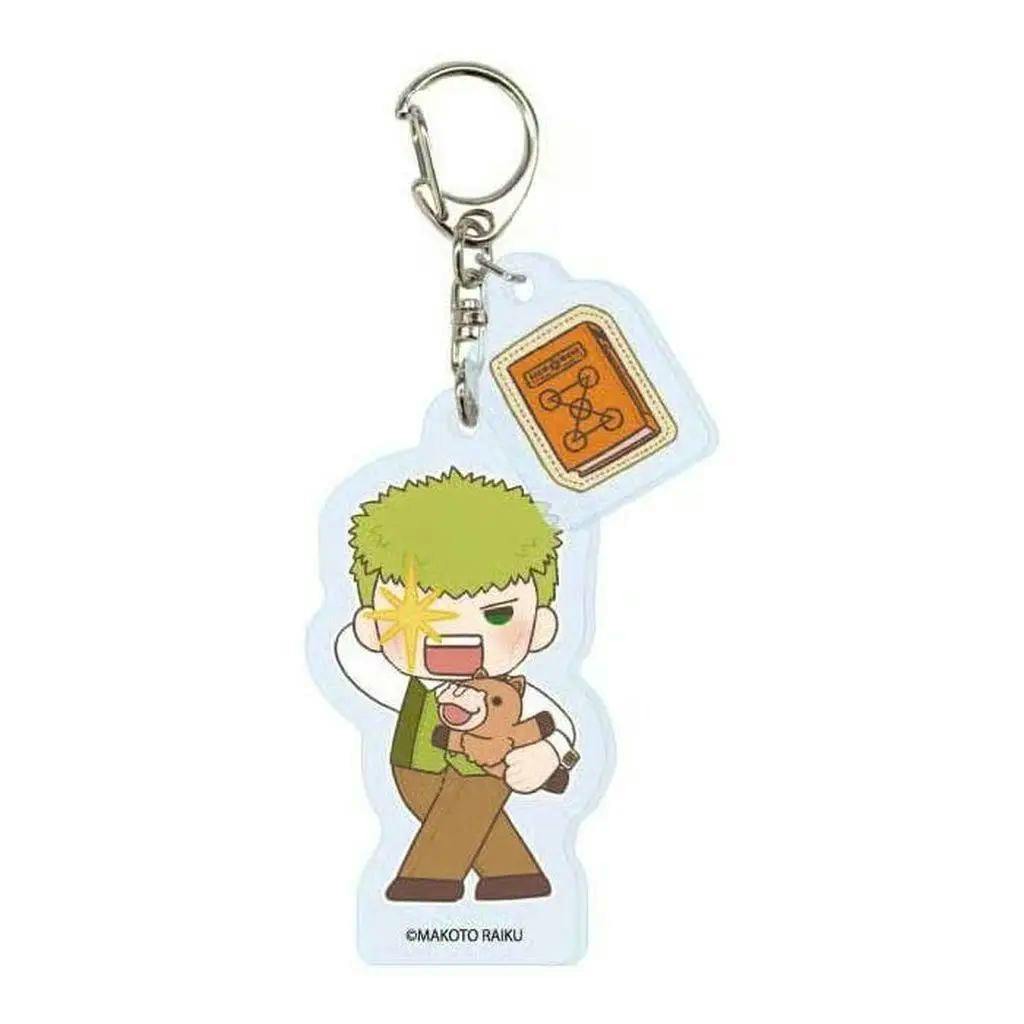Acrylic keychain featuring a chibi character with green hair holding a small brown animal and an attached small orange book charm.